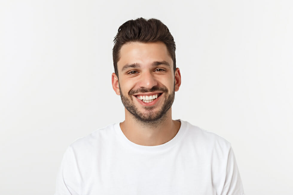 young man in white shirt with big smile